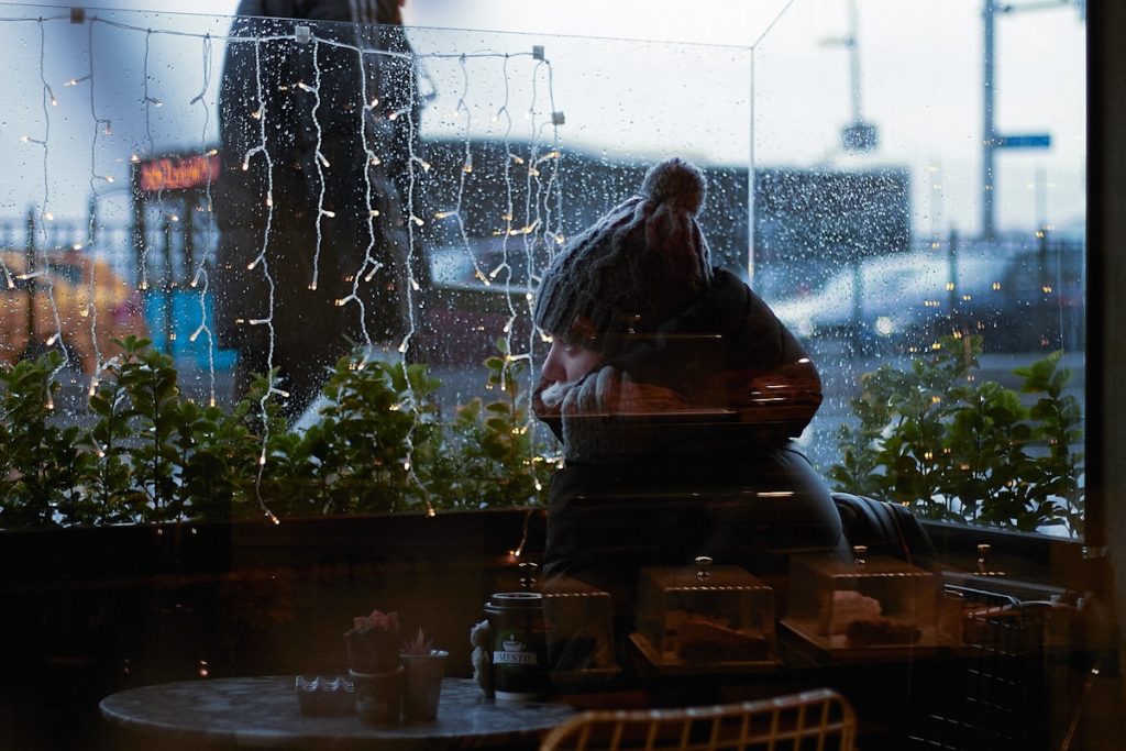 "Person looking through window alone"