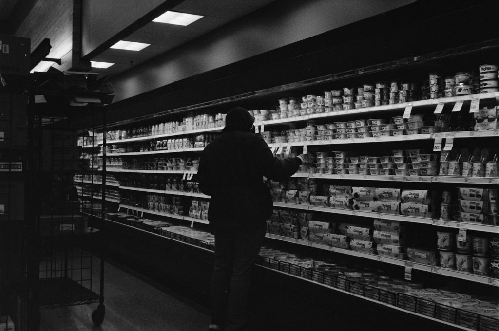 Person shopping in a grocery store aisle